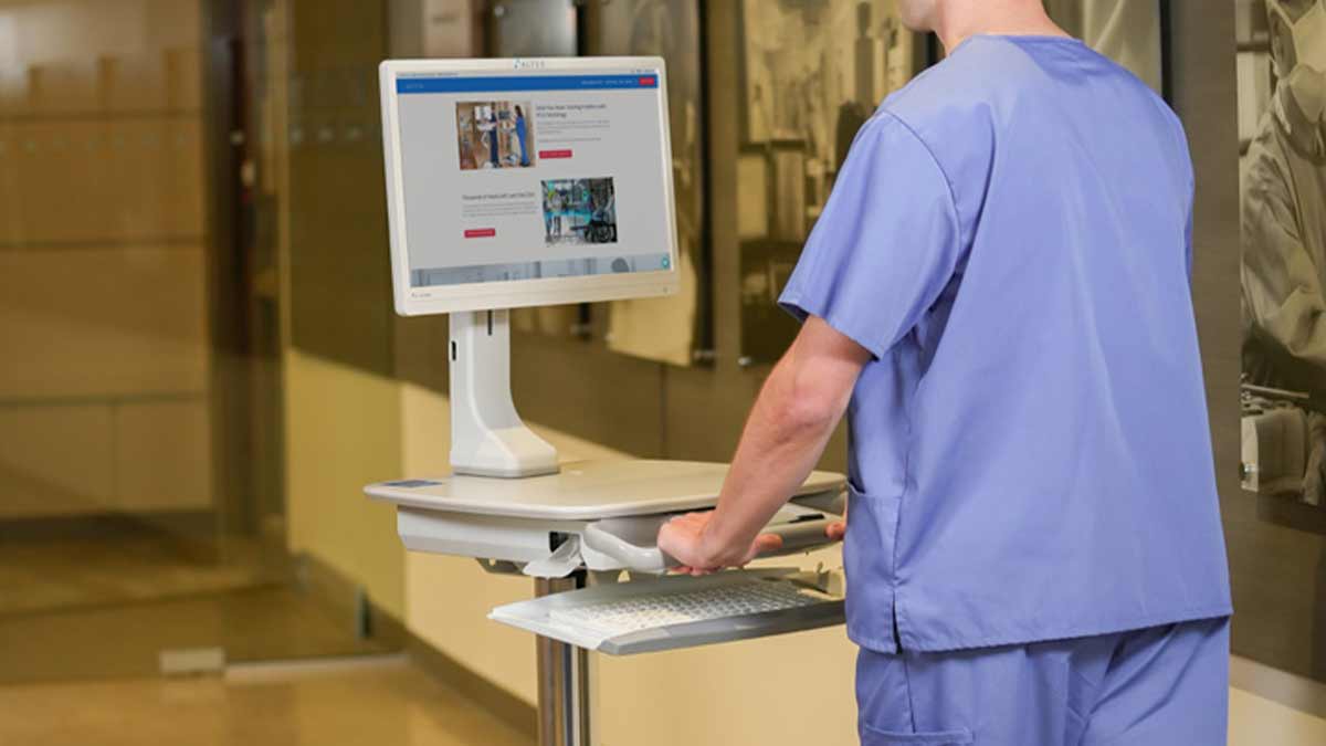 medical-laptop-cart Medical laptop cart in hospital hallway with nurse